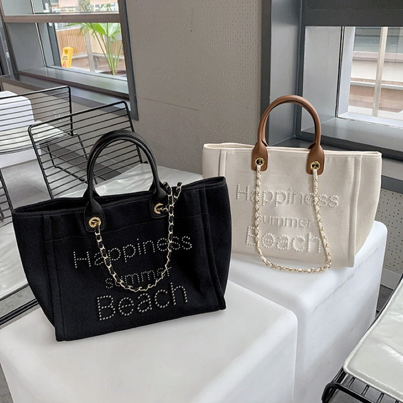 Bolsa de praia em lona com alça de couro e detalhes de pérolas, estilo tote único, com alça de ombro